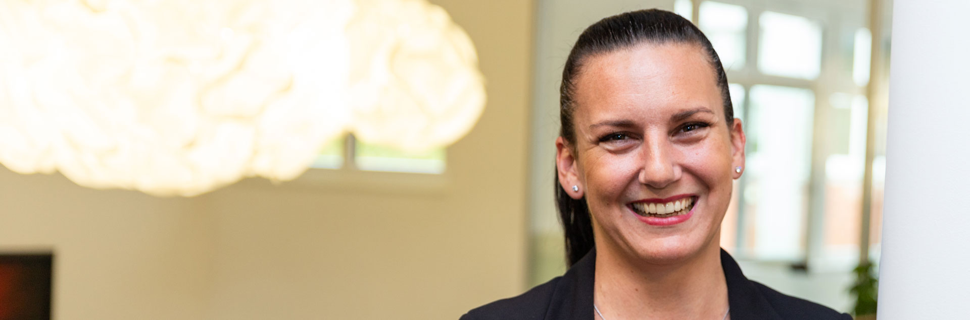 A employee smiling to the camera.